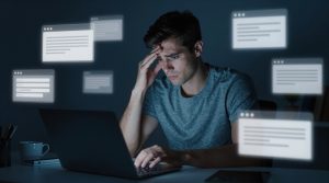 Man with Head in Hand at Laptop